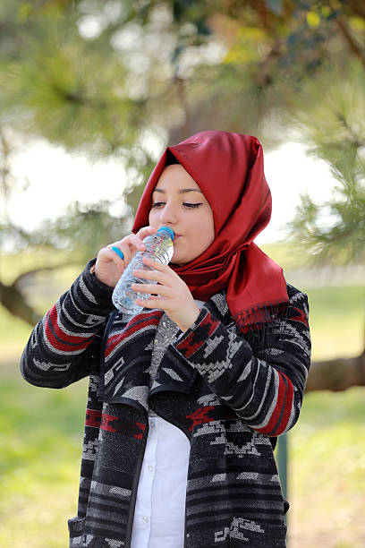 istock Muslim woman drinking water 510157250