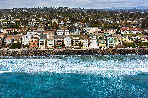 Southern California Oceanfront Neighborhood From Above Rows of homes along the rocky coastline of the southern California city of Oceanside located in northern San Diego County.  I shot this image from a chartered helicopter during a photo-flight at an elevation of about 400 feet.   rocky coastline stock pictures, royalty-free photos & images