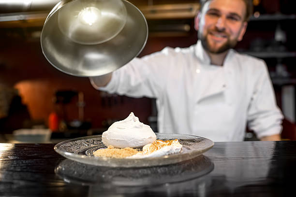 Chef cook serving dessert to the client