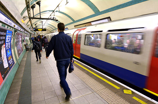 London, United Kingdom - May 14, 2015: Passengers travel on  London Underground platform. The Annual passenger numbers of london Underground is 1.265 billion