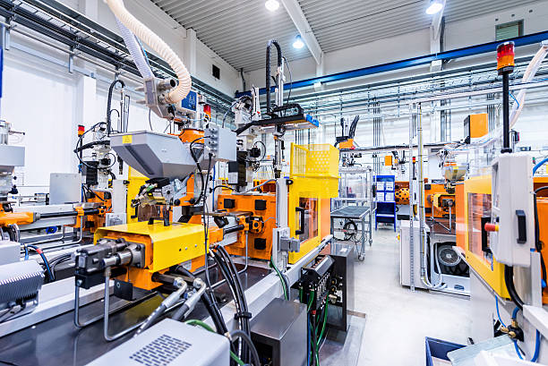 Production line of plastic industry Horizontal color image of large group of automated injection moulding machines for plastic parts production. construction machinery photos stock pictures, royalty-free photos & images