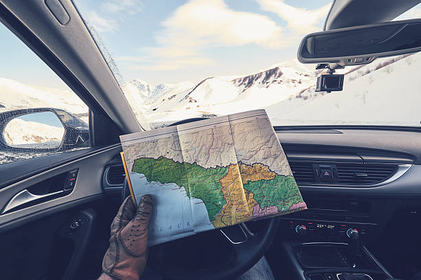 istock Driver lost without gps and looking in to map pov 510164032