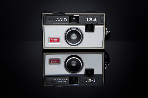 Woodbridge, New Jersey, USA - February 20, 2014: A Kodak Instamatic 134 camera sits on a black reflective surface. This camera was marketed from 1968-1971, took 126 film, and retailed for $25.50 US dollars.