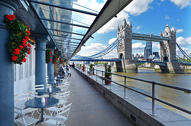 Shad Thames London - England United Kingdom London, United Kingdom - May 13, 2015: People walk past a restaurant overlooking Tower Bridge in Shad Thames or Butler's Wharf in London England UK. It is an historic riverside street next to Tower Bridge in Bermondsey, London, England. bankside photos stock pictures, royalty-free photos & images