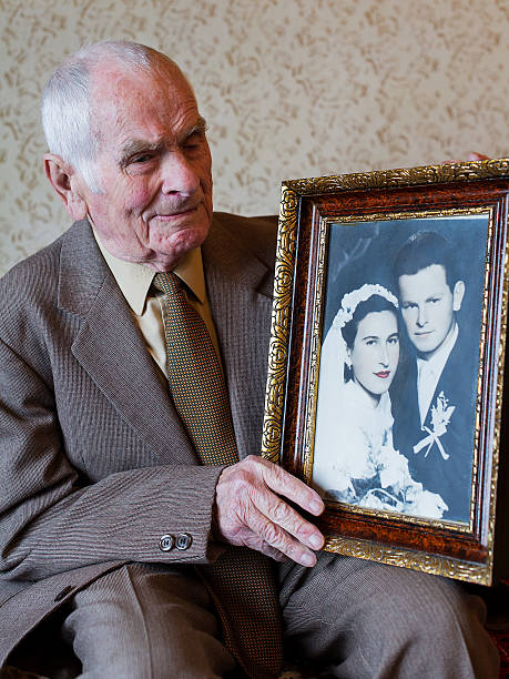 istock Handsome 80 plus year old man holding his wedding photograph. 510167296