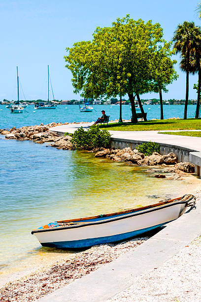 Sarasota, FL, USA - May 20, 2015: Small boat anchored on the beach at Bayfront Park in downtown Sarasota Florida