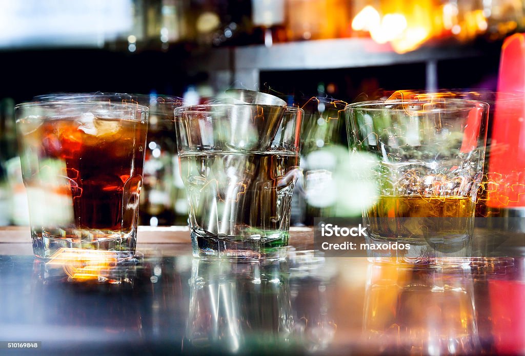 Cocktails with ice Abstraction Cocktails with ice and Bar inventory at nightclub. Shot on a long exposure Abstract Stock Photo