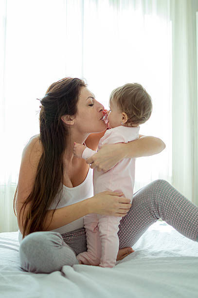 istock Baby with her momy sharing pacifier 510173534