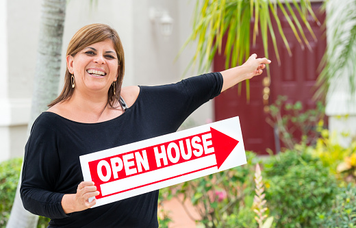 hispanic female Real Estate Agent at an Open House