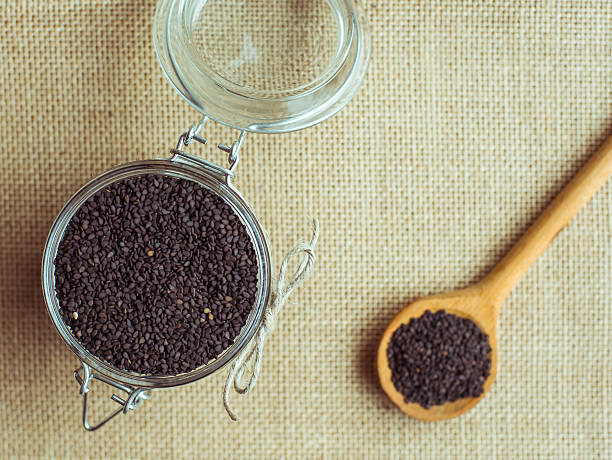istock Black Sesame (close-up shot) on wooden background. 510173778