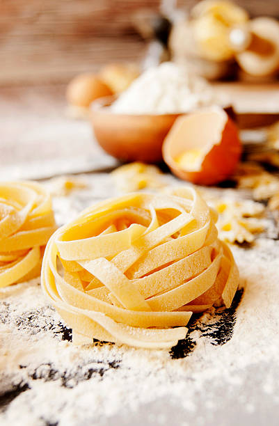 istock Uncooked pasta with flour on the table, selective focus 510174278
