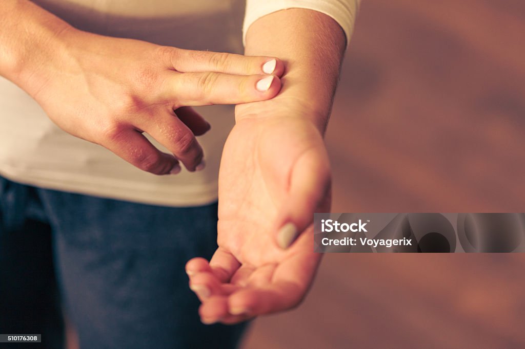 Woman checking pulse on wrist closeup Medicine health care. Female hand checking pulse on wrist closeup. Taking Pulse Stock Photo