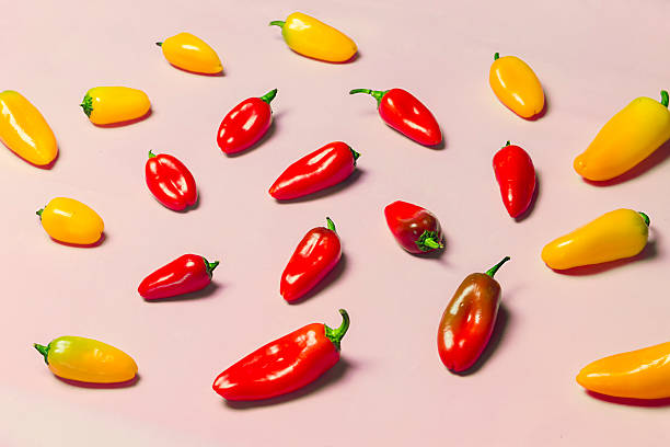 istock Yellow and Red Sweet Peppers on Pink Background 510177468