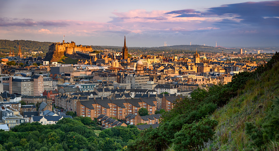 Edinburgh, Scotland - 7th August 2023: The rear of Edinburgh Castle, including part of the volcanic plug rock, seen over part of the Flodden Wall, which was built as a city defence in the 16th century.