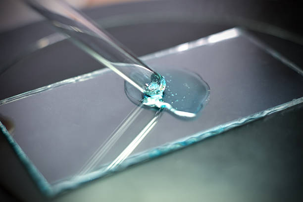 istock pipette takes a sample of blue liquid 510178416
