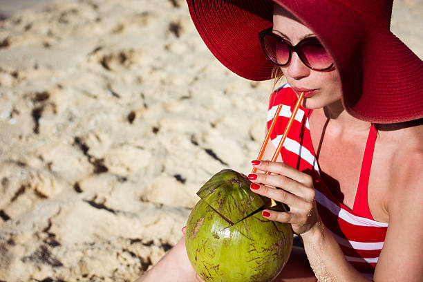 istock Young woman drinking coconut water 510179126