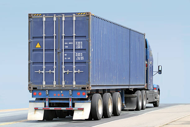 Semi Truck Hauling A Large Shipping Container stock photo