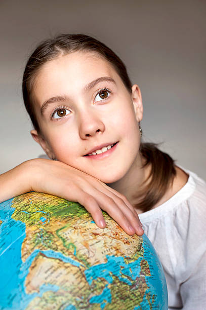 istock Thoughtful girl with blue round globe dreaming about adventure 510183807
