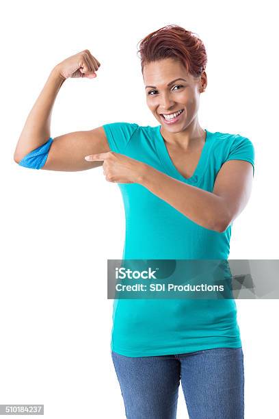 African American Woman Pointing To Bandaged Arm After Donating Blood Stock Photo - Download Image Now