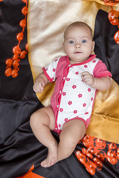 istock Baby lies on bedding 510185275