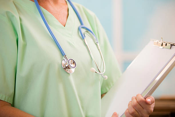 istock Female doctor or nurse holds blank medical chart, document. 510198961