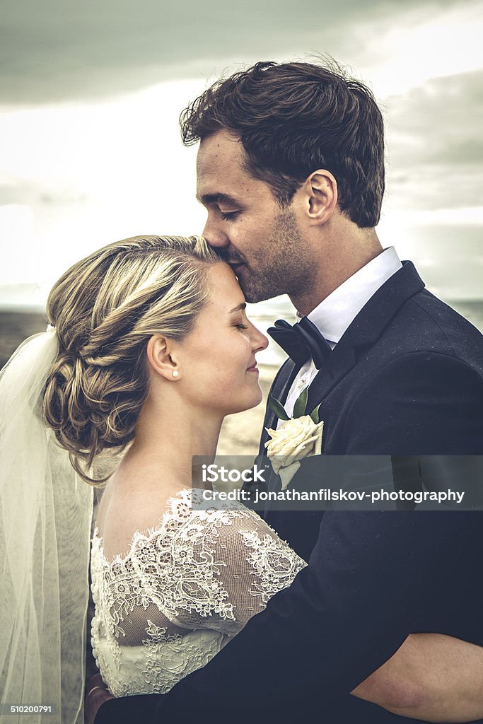 Newly weds Just married: Wedding picture of young, beautiful couple standing on beach, Denmark Wedding Stock Photo