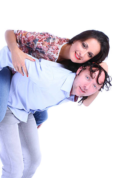 Man and woman peeking from behind an ad space against stock photo