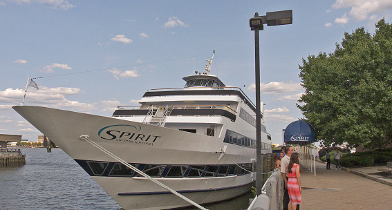 Philadelphia, Pennsylvania, USA - August 8, 2014: People line up to board  the Spirit of Philadelphia ship at Penn's Landing. The ship offers day - night dinner and sight seeing cruises on the Delaware River. Fun for people of all ages.