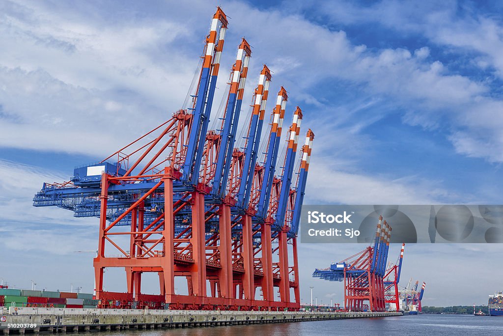 Container Terminal in port Large gantry cranes in a container terminal in the port of Hamburg. Cargo Container Stock Photo