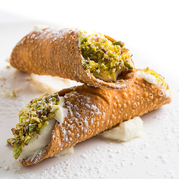 close up of two pistachio cannoli on white background Pistachio Cannoli on white background cannoli photos stock pictures, royalty-free photos & images