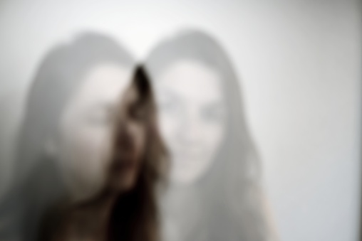 Out of focus multiple exposure portrait of a young Caucasian woman.