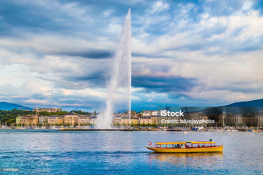 City of Geneva with Jet d'Eau fountain at sunset, Switzerland Beautiful view of Geneva skyline with famous Jet d'Eau fountain at harbor district in beautiful evening light, Switzerland. Geneva - Switzerland Stock Photo