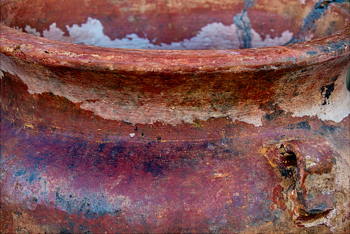 Old peeling paint on rusted iron surface with corrosion spots