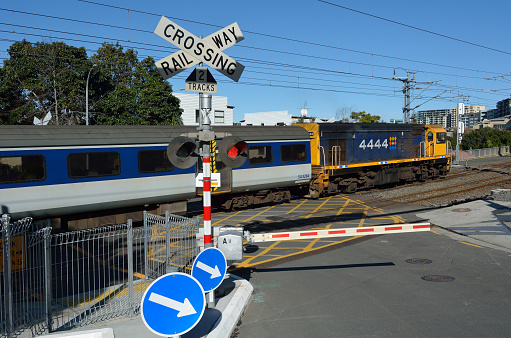 Auckland, New Zealand - July 9, 2015: MAXX train in crossing railway. On average, each year 400 people are killed in the European Union and over 300 in the United States in level crossing accidents.