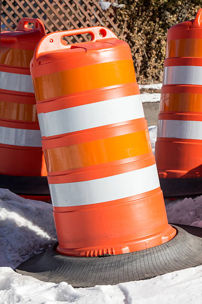 istock Orange and white traffic barrels in snow 510216304