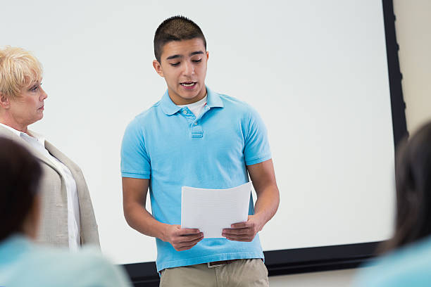 istock Nervous private high school student reads report to class 510220234