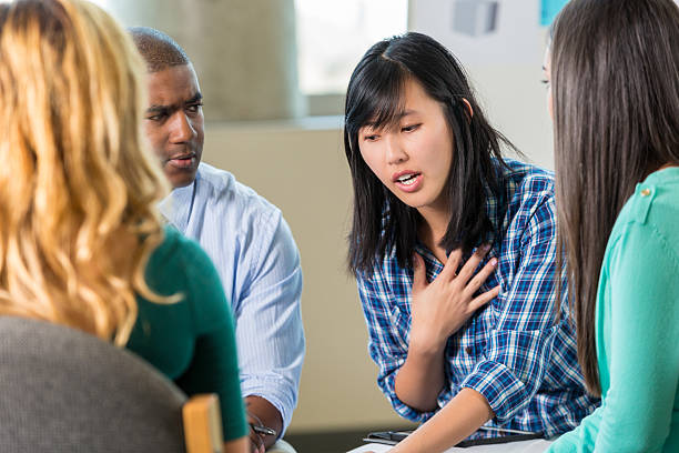 istock Young Asian woman talks in support group 510220404