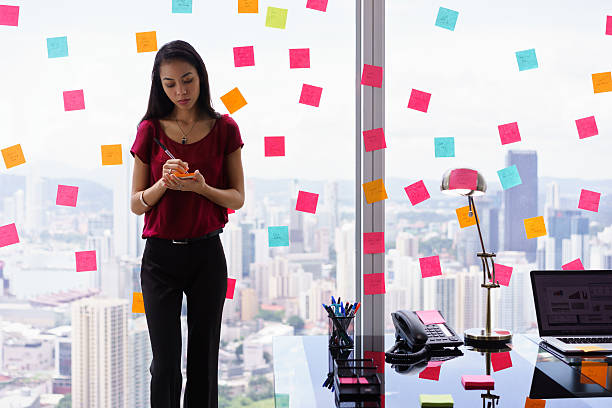 istock Chaotic Office With Secretary Writing Sticky Notes On Window 510220476