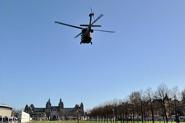 Amsterdam, The Netherlands - March 24, 2014: Two Sikorski VH-60N helicopters from the security detail of US president Barack Obama about to land on the Museumplein just before the president will arrive with Marine One for his visit to the Rijksmuseum. This visit took place as part of the presidential program during the Nuclear Security Summit.