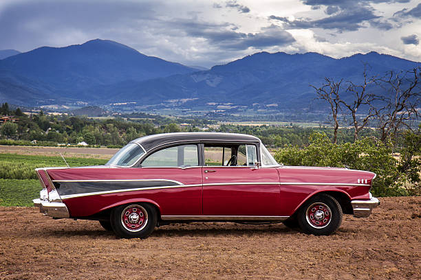 1957 Chevrolet 1957 Chevy Bel Air in classic red and black with dramatic background (logos removed). porsche classic sports car obsolete stock pictures, royalty-free photos & images