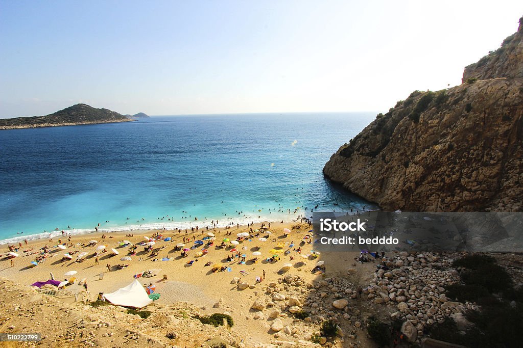 Kas, Antalya, Turkey Sailboats and sunbathing people in Kaputas Beach in Kalkan,Antalya,Turkey. Antalya Harbor Stock Photo