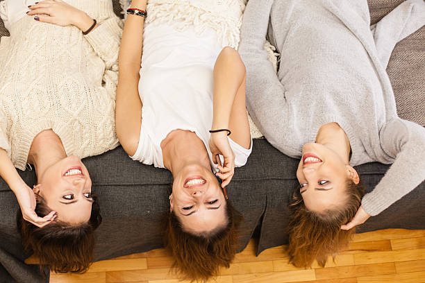 istock Three girls having fun, lying on bed 510224826