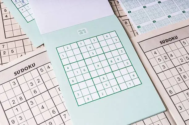 Photo of Many blank sudoku crosswords. Popular logic game with numbers.