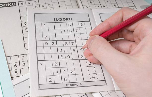 istock Hand is solving sudoku crossword, popular puzzle game. 510225756