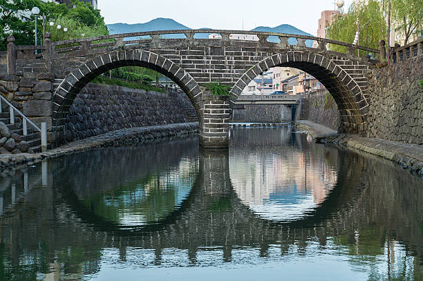 Meganebashi (Spectacles Bridge) in Nagasaki, Japan Meganebashi (Spectacles Bridge) was built in Nagasaki in 1634. It's a oldest stone arch bridge in Japan, and has been designated as an Important Cultural Property. nagasaki prefecture photos stock pictures, royalty-free photos & images