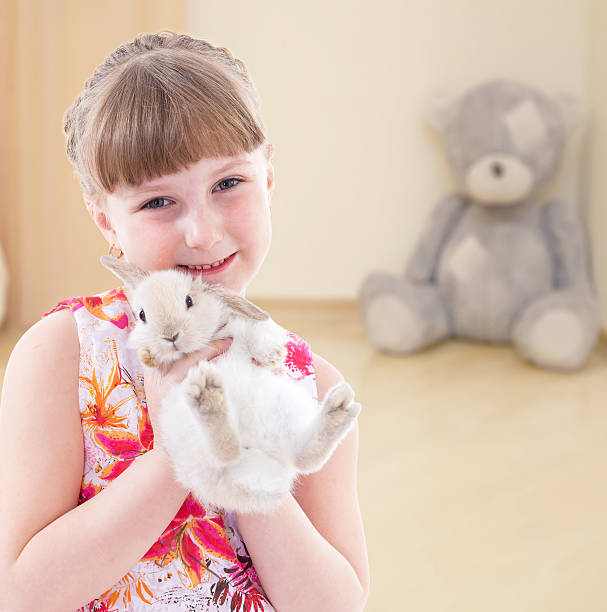 istock girl kissing a rabbit. 510226253
