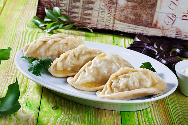manti ravioli large dumplings plate with sour cream and dill stock photo