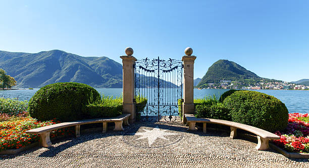 Gate at lake of Villa Ciani Lugano, Switzerland: Images of the Gulf of Lugano and Ciani park, botanical park of the city. The Gate at lake of Villa Ciani. lugano stock pictures, royalty-free photos & images
