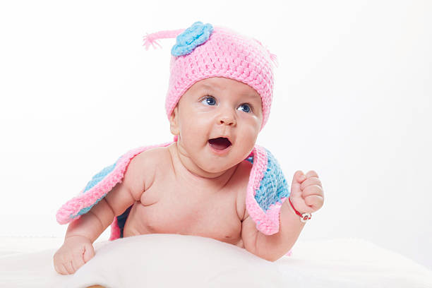 portrait of cute baby girl with blue eyes playing with plane indoors.