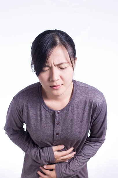 istock Woman Has Stomach Ache on Isolated White Background 510230644